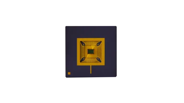 Top view of a compact QRNG microchip with symmetrical gold structure on dark substrate